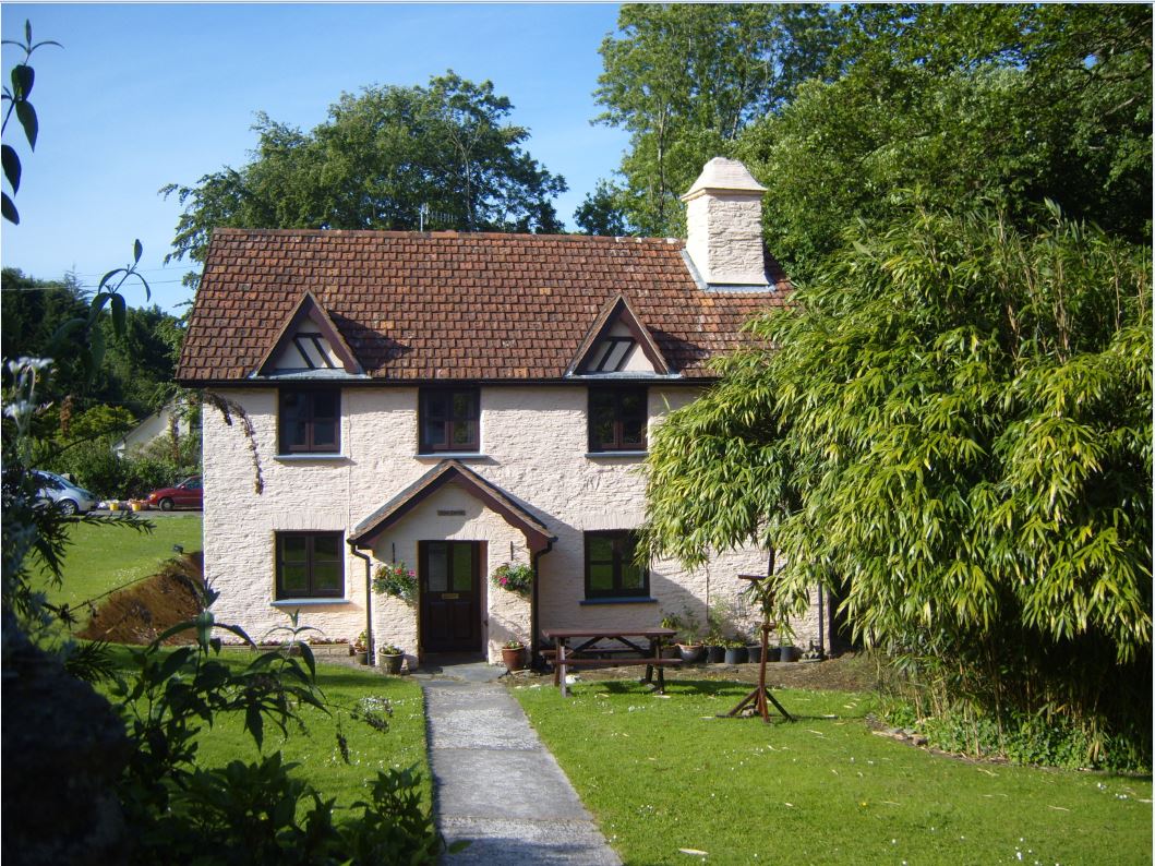 On the corner opposite bus stop.